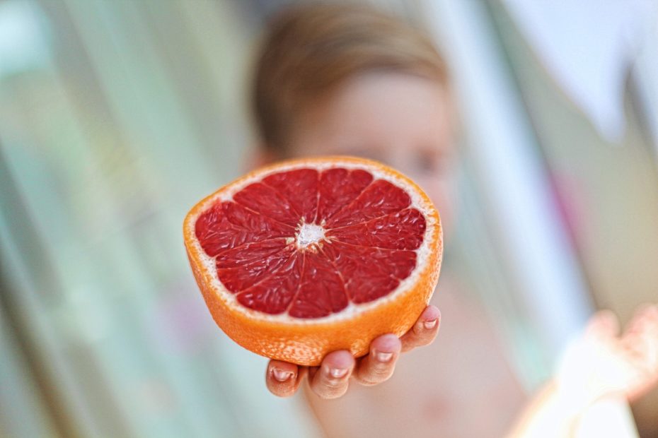 kid holding an orange
